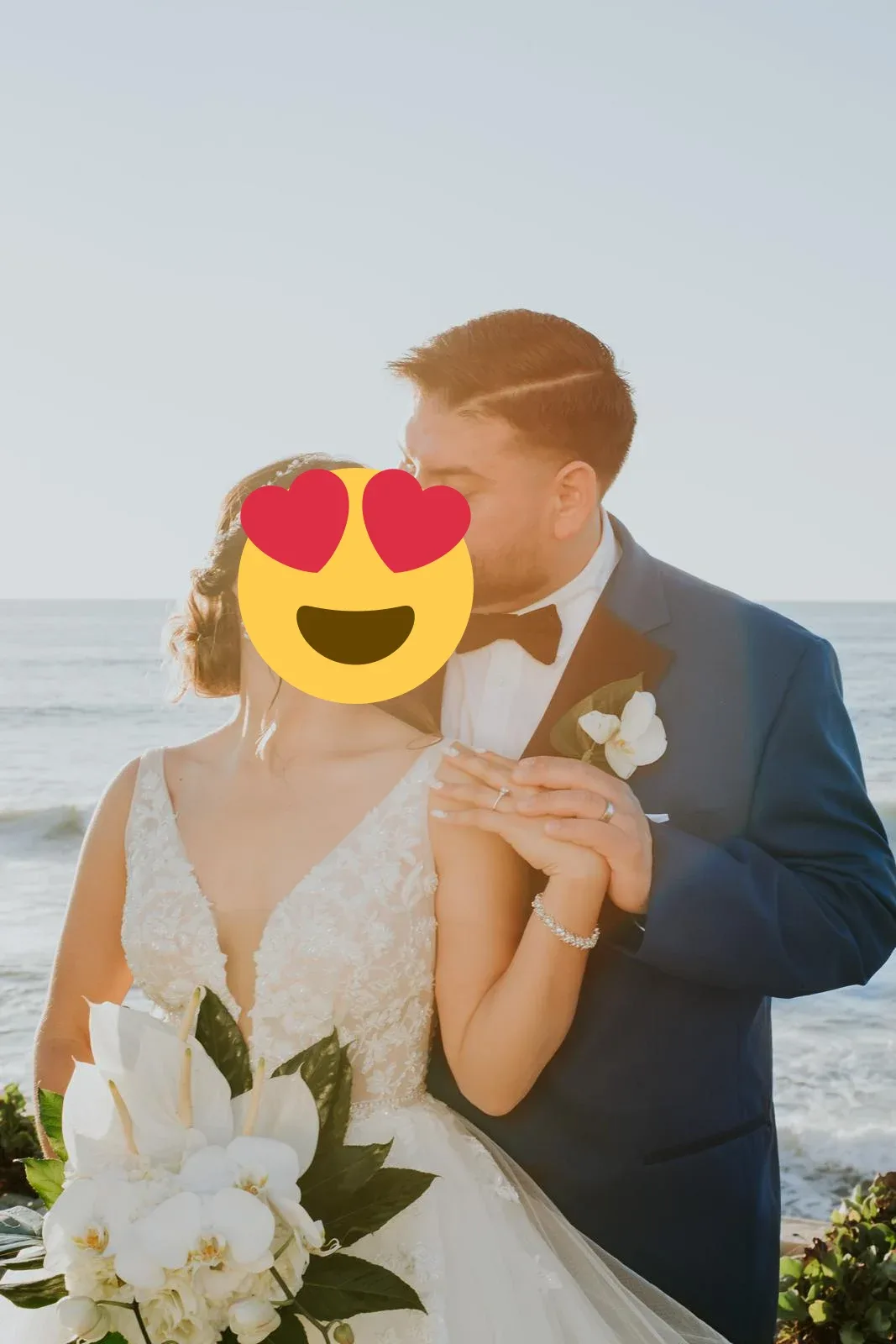 A wedding couple with a white orchid bouquet in soft coastal sunlight