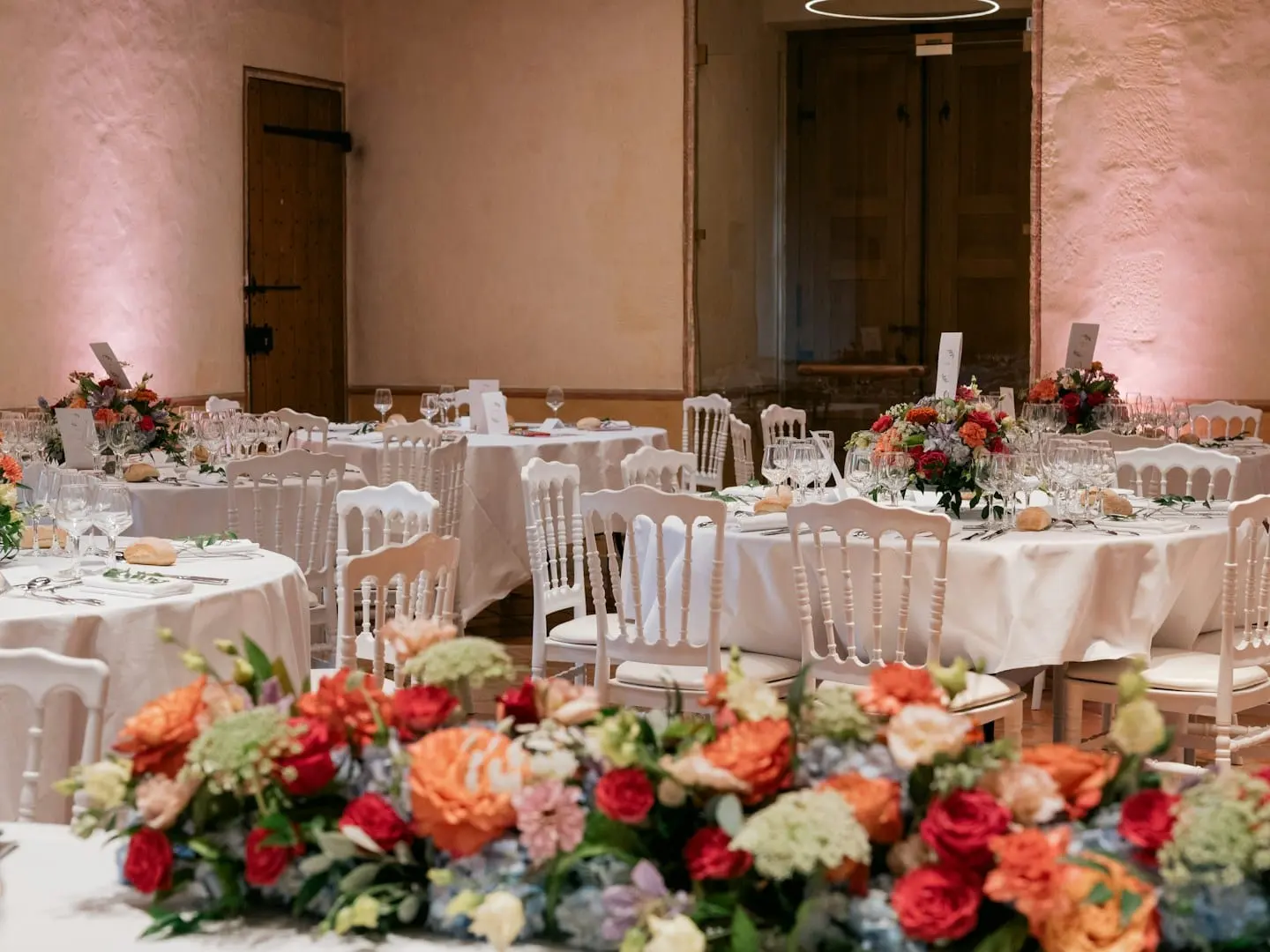 Wedding reception tables with colorful floral centerpieces